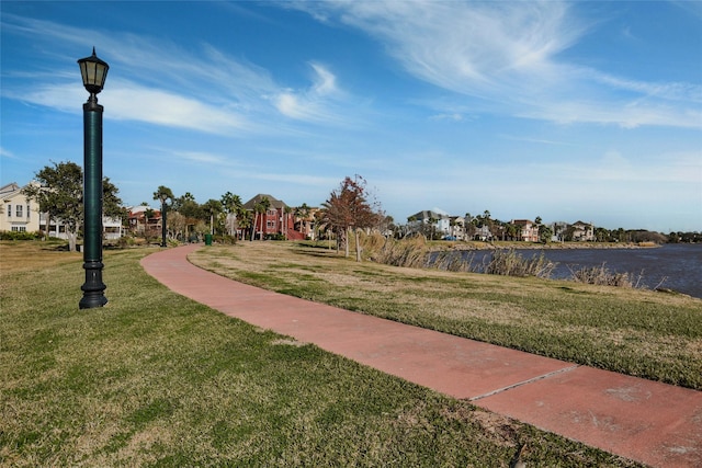 view of property's community featuring a residential view and a lawn