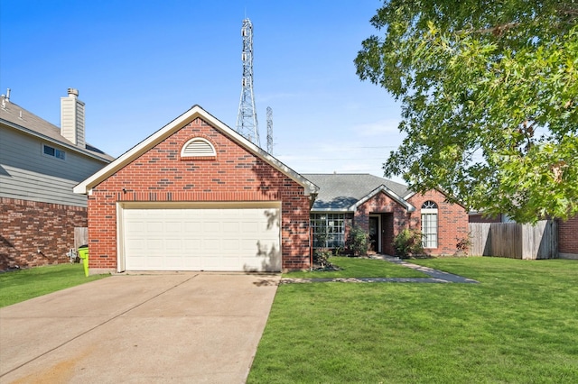 ranch-style house with driveway, brick siding, fence, and a front yard