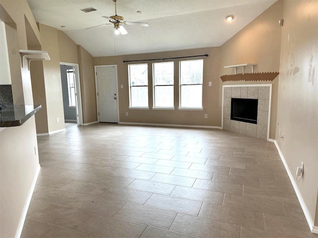 unfurnished living room with visible vents, baseboards, vaulted ceiling, and ceiling fan