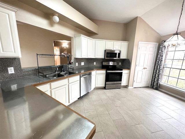 kitchen with white cabinetry, decorative backsplash, a sink, and stainless steel appliances