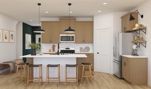 kitchen featuring a kitchen bar, stainless steel appliances, light countertops, and light wood-type flooring