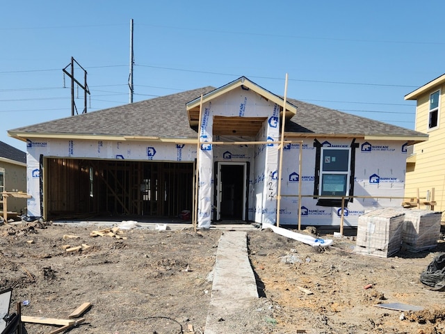 property in mid-construction with a garage and a shingled roof
