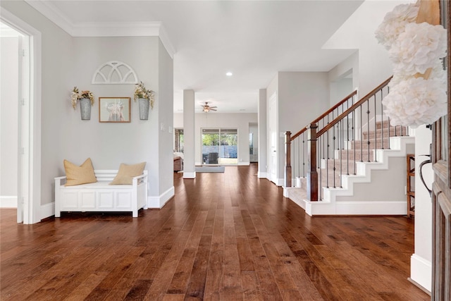 entryway with baseboards, crown molding, stairway, and dark wood-style flooring