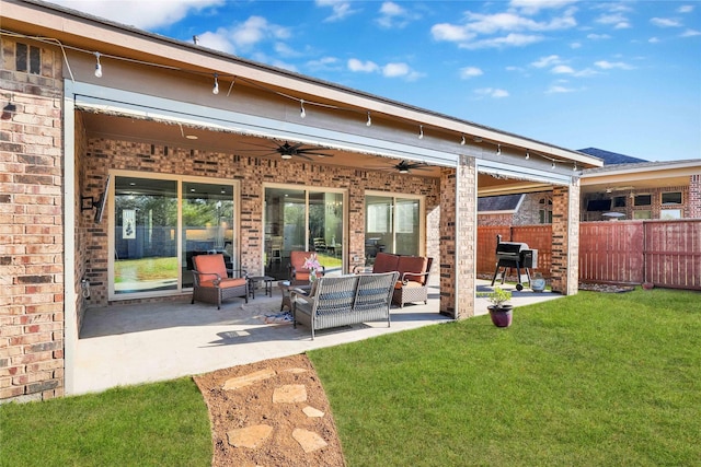 back of property with an outdoor hangout area, a patio, brick siding, and fence