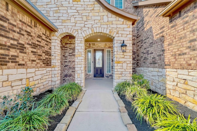 doorway to property with a porch and brick siding