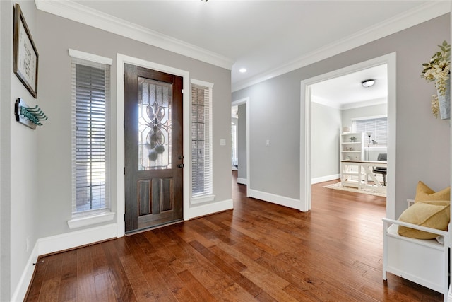 foyer featuring hardwood / wood-style flooring, baseboards, and ornamental molding