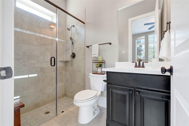 full bathroom featuring toilet, tile patterned floors, a shower stall, and vanity