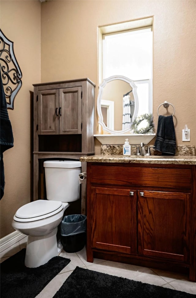 bathroom with vanity, toilet, and tile patterned floors