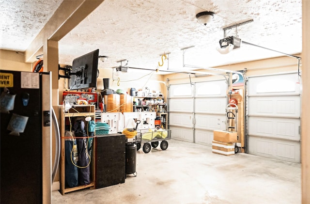 garage with a garage door opener and freestanding refrigerator