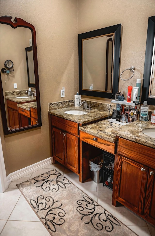 bathroom with vanity, baseboards, and tile patterned floors