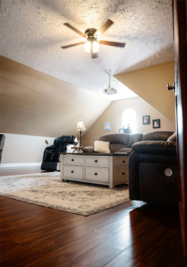 unfurnished bedroom with lofted ceiling, ceiling fan, a textured ceiling, and wood finished floors