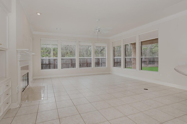 unfurnished sunroom with a wealth of natural light, a fireplace, and ceiling fan