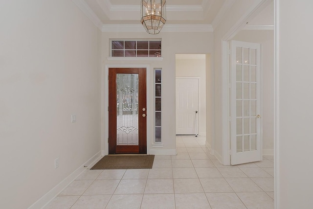 entrance foyer with crown molding, baseboards, and light tile patterned floors