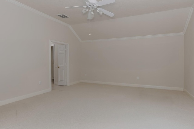 unfurnished room with crown molding, lofted ceiling, visible vents, and light colored carpet