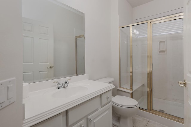 bathroom with toilet, a shower stall, tile patterned flooring, and vanity