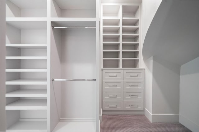 walk in closet featuring carpet floors