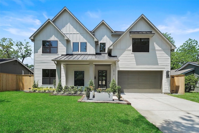 modern farmhouse featuring driveway, a standing seam roof, fence, board and batten siding, and a front yard