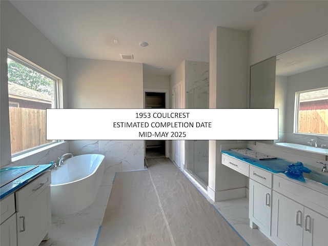 bathroom with marble finish floor, visible vents, and plenty of natural light