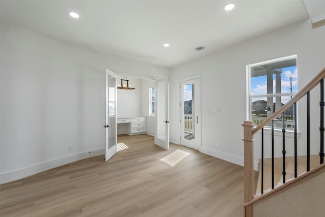 interior space featuring recessed lighting, visible vents, plenty of natural light, and stairway