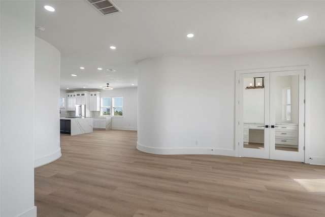 unfurnished room with visible vents, light wood-style flooring, and recessed lighting