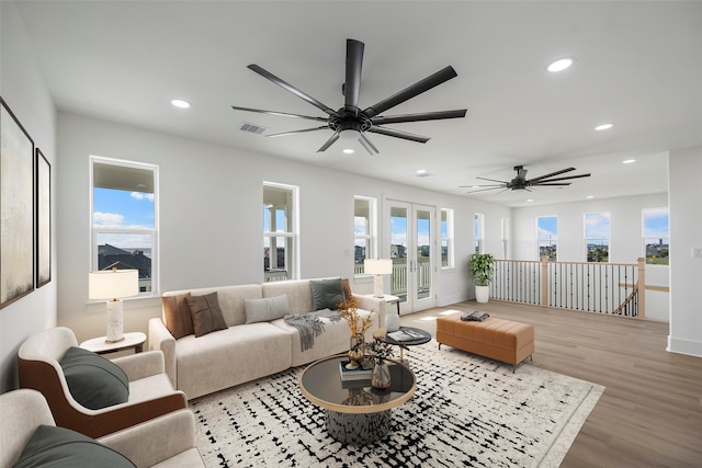 living room featuring recessed lighting, visible vents, and wood finished floors