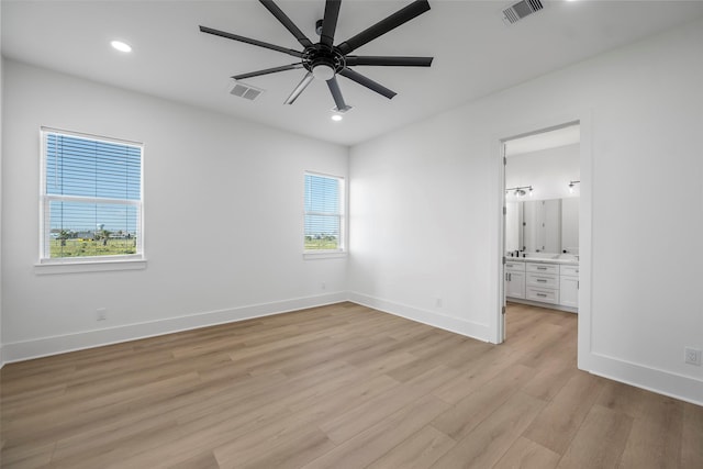 unfurnished bedroom featuring light wood-type flooring, baseboards, and visible vents