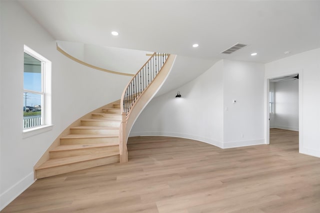 stairway featuring baseboards, wood finished floors, visible vents, and recessed lighting