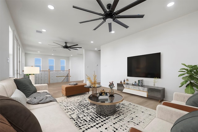 living room with visible vents, wood finished floors, and recessed lighting