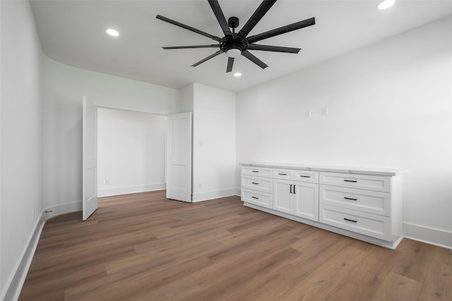 empty room featuring light wood-style floors, recessed lighting, ceiling fan, and baseboards