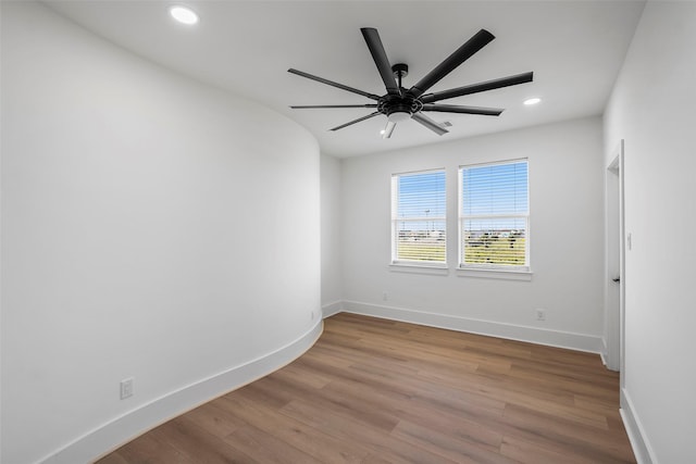 empty room with recessed lighting, ceiling fan, baseboards, and wood finished floors