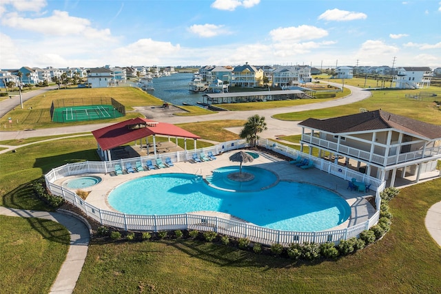 community pool with a patio area, a residential view, and fence