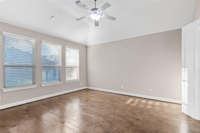 unfurnished room featuring lofted ceiling, a ceiling fan, visible vents, and wood finished floors