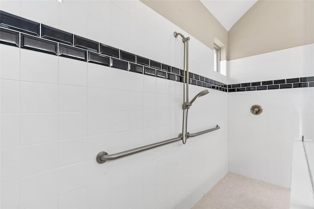 interior details featuring a tile shower