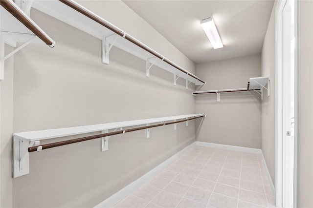 spacious closet with light tile patterned floors