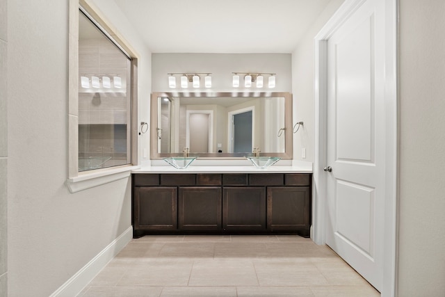 bathroom featuring double vanity and baseboards