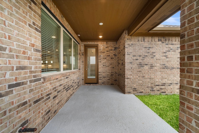 property entrance with brick siding