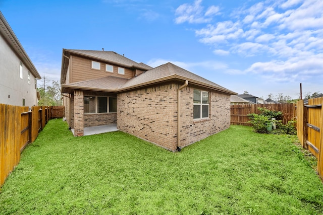 rear view of house featuring a patio area, a lawn, and brick siding