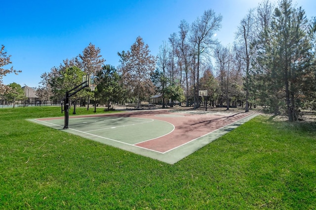 view of basketball court with community basketball court and a yard