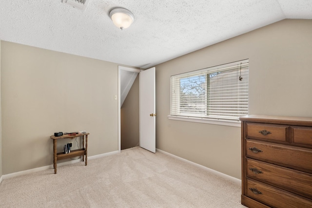 bedroom with visible vents, light carpet, vaulted ceiling, a textured ceiling, and baseboards