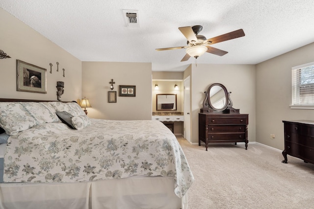 bedroom featuring a textured ceiling, light carpet, a ceiling fan, visible vents, and baseboards