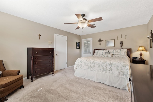 bedroom with light colored carpet, ceiling fan, visible vents, and baseboards