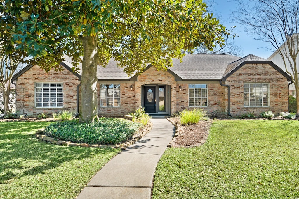 12706 Shady Knoll Ln, Cypress, TX 77429 - view of front of house featuring brick siding, a shingled roof, and a front yard