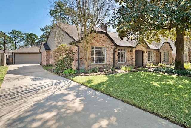 view of front of property featuring a garage, a chimney, a front lawn, and brick siding