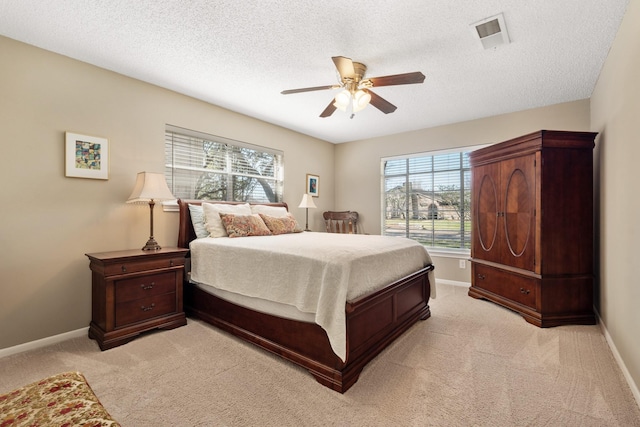 bedroom with visible vents, baseboards, and multiple windows