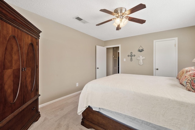 bedroom with a textured ceiling, light carpet, a ceiling fan, visible vents, and baseboards