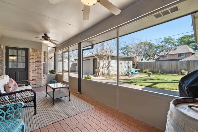 sunroom / solarium with a ceiling fan