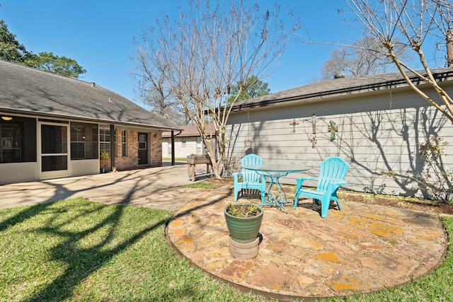 view of yard featuring a sunroom and a patio area