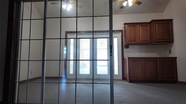 interior details featuring french doors, carpet, and a ceiling fan