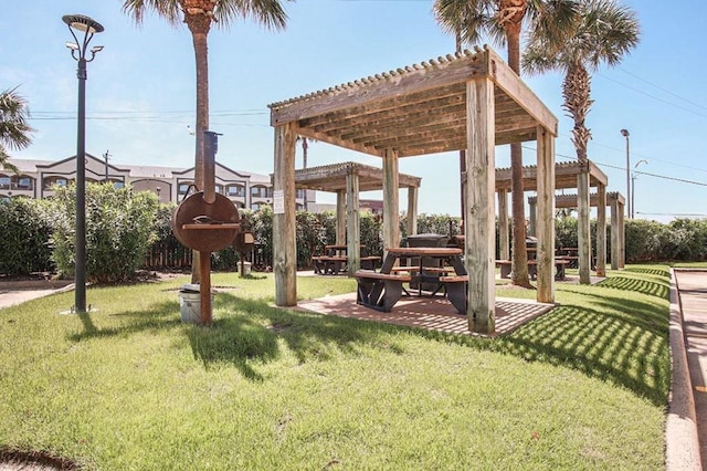 surrounding community featuring a yard and a pergola