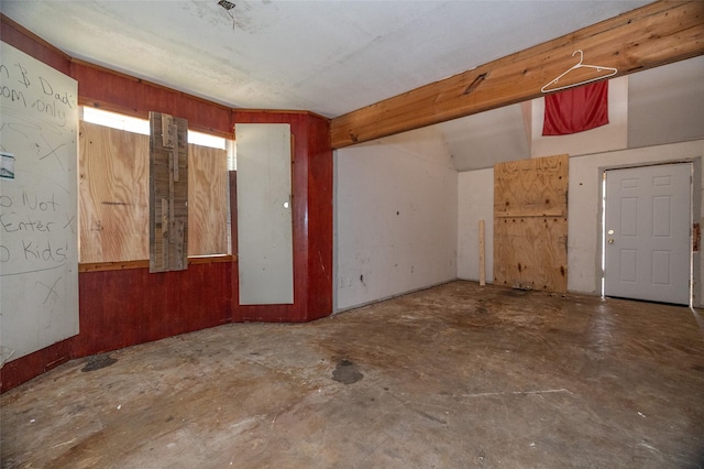 unfurnished room with unfinished concrete floors